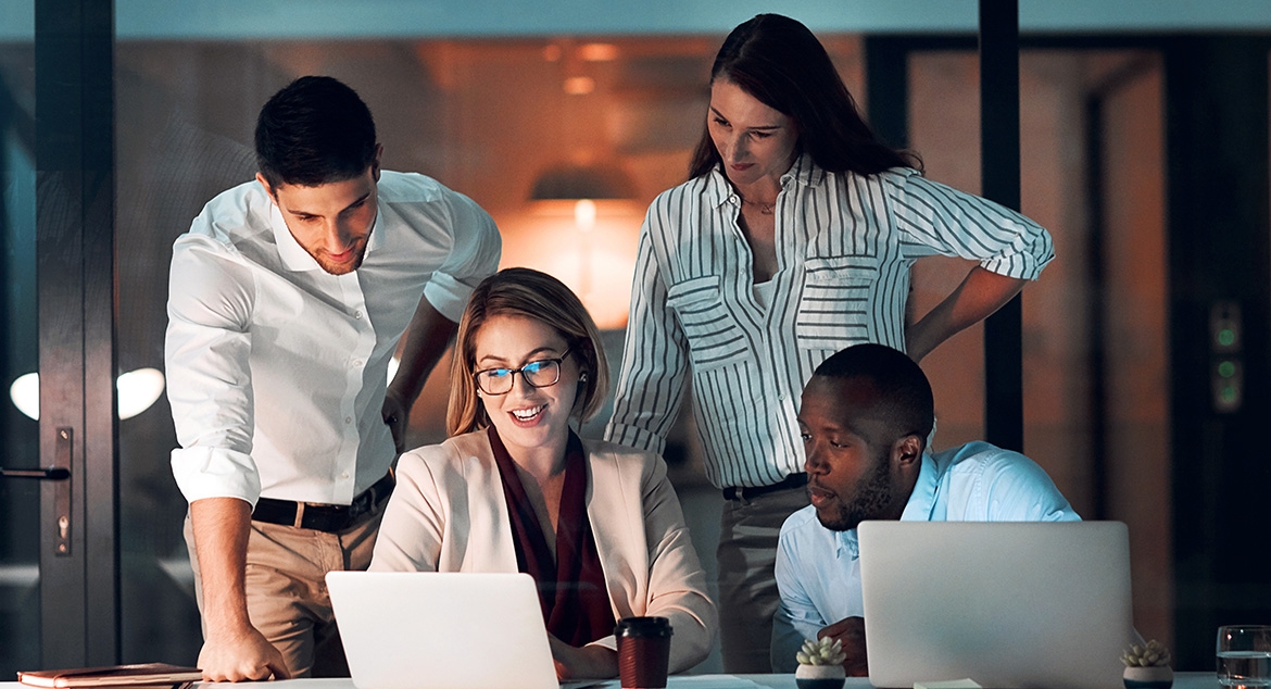 Group of individuals looking at laptops