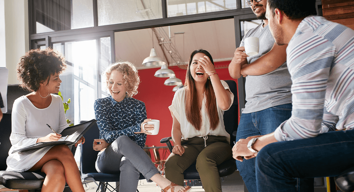 co-workers sitting in a circle laughing