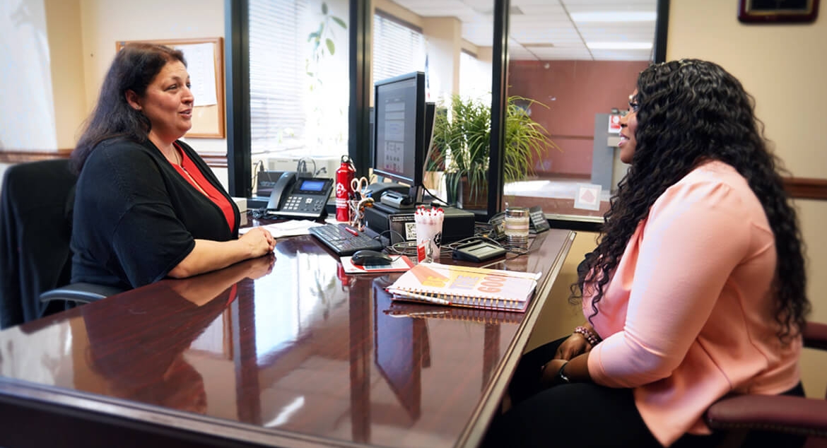 Erika Coleman meets with NOFFCU Financial Inclusion Manager Rachel Smith, CCUFC. The credit union’s personalized solutions helped Coleman take steps toward a solid financial future.