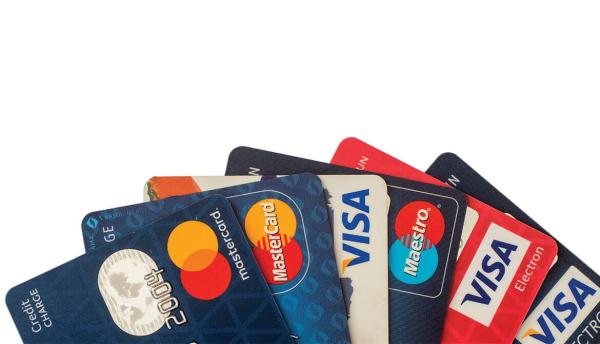 colorful fan of red white and blue credit cards from Visa and Mastercard