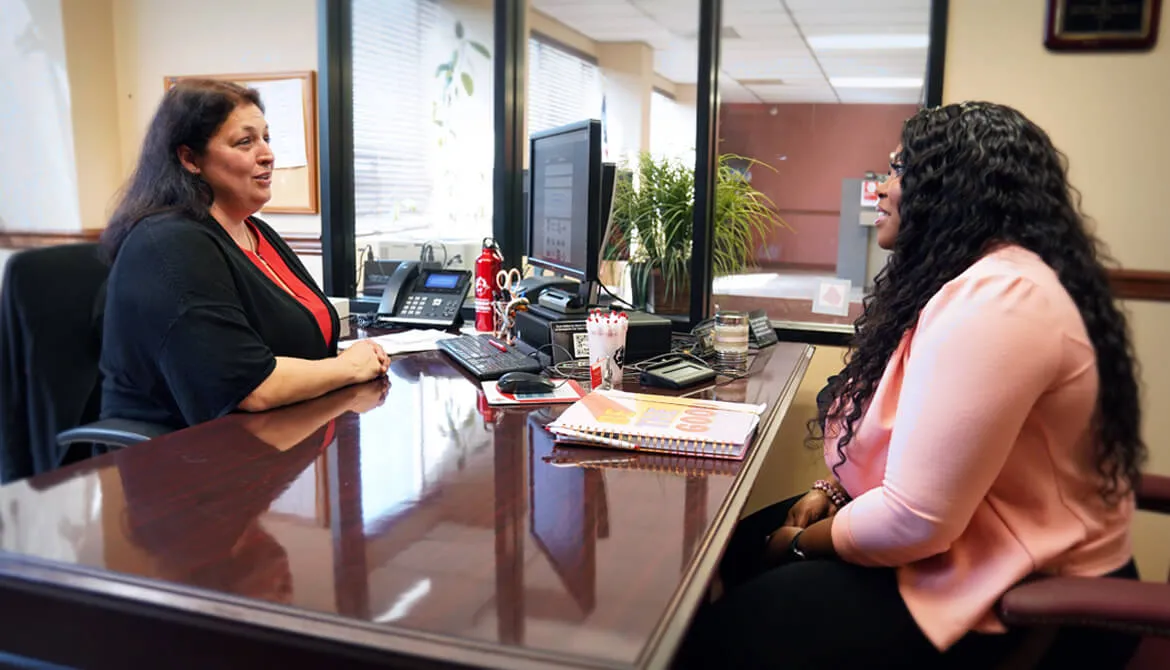 Erika Coleman meets with NOFFCU Financial Inclusion Manager Rachel Smith, CCUFC. The credit union’s personalized solutions helped Coleman take steps toward a solid financial future.
