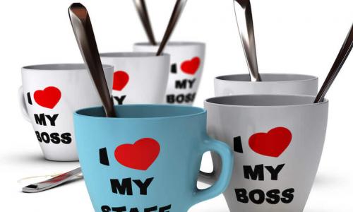 Collection of white and blue mugs that say “I heart (sic) my staff” and “I heart (sic) my boss”