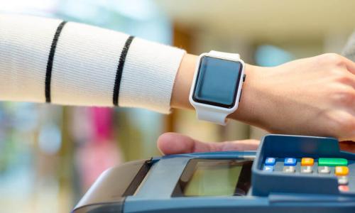 woman paying using her Apple Watch to pay