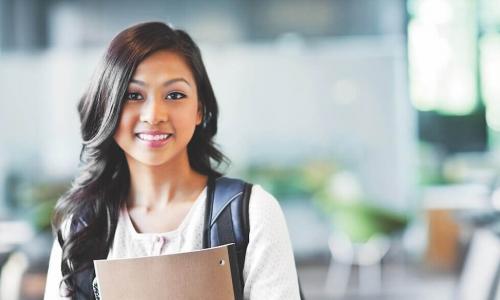 young female student holds notebook