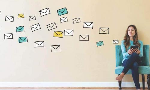 young woman sitting in a chair using a mobile device, with drawn images of envelopes floating off to the side