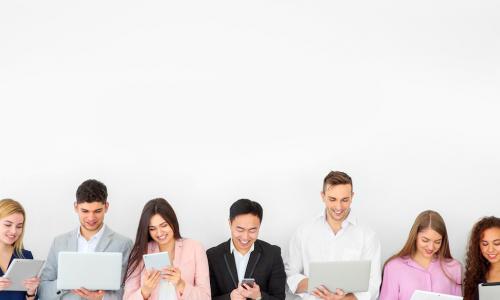 A row of young businesspeople all communicating via digital devices