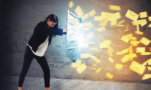 Woman holding up a shield blocking a barrage of spam emails