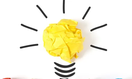 colorful crumpled paper transforms into idea lightbulb