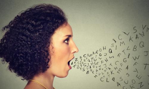 Woman talking with alphabet letters coming out of mouth