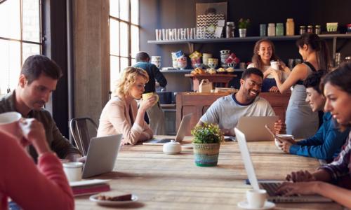 many customers working on laptops at a coffee shop