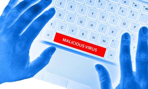 techy looking blue hands on keyboard with a space bar that says malicious virus