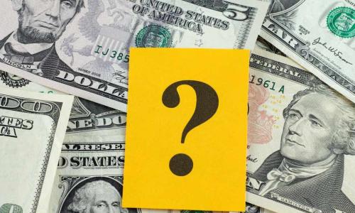 question mark over dollar bills