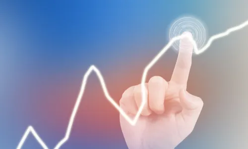 finger pointing at a bump in financial graph