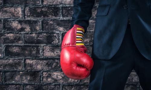executive wearing red boxing glove