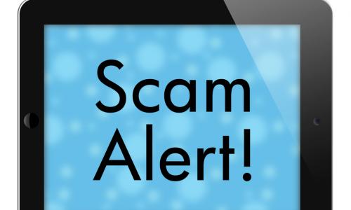tablet with words scam alert