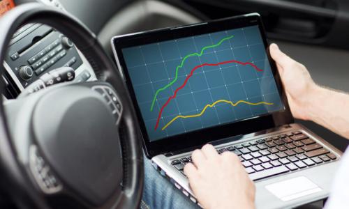 close up of man using laptop computer in car