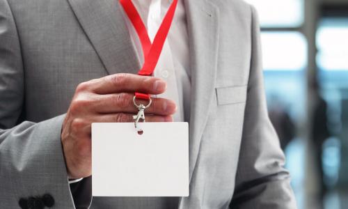 Businessman holding blank ID badge