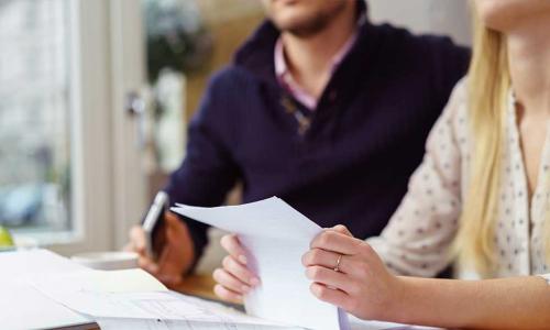 couple reading a contract in an office