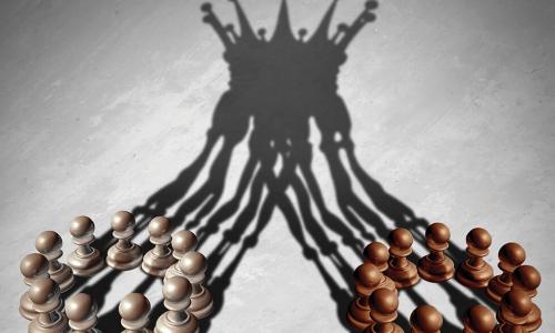 shadows of many chess pawns merging to create the image of a queen