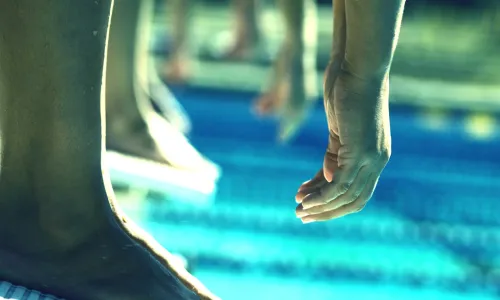 Feet on diving board getting ready to dive