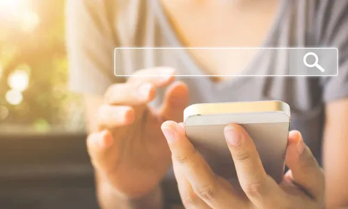 woman holding a phone overlayed with a search bar