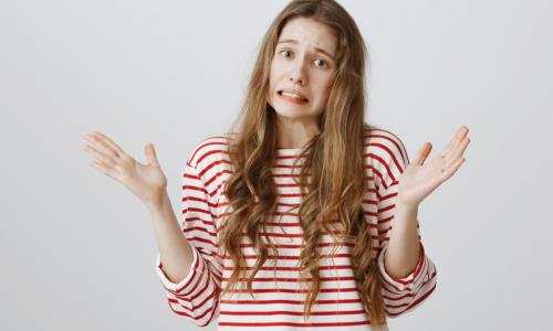 young woman in red and white striped shirt looking guilty