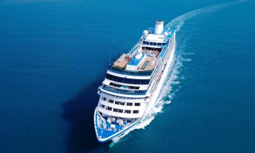 giant cruise ship sailing through blue sea