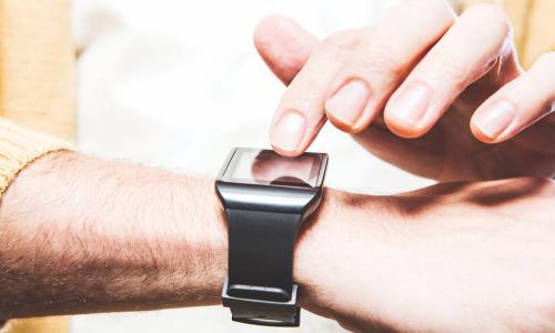 man checks his smartwatch