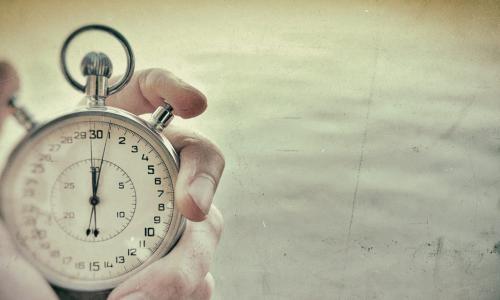 old photo of hand holding chrome stopwatch