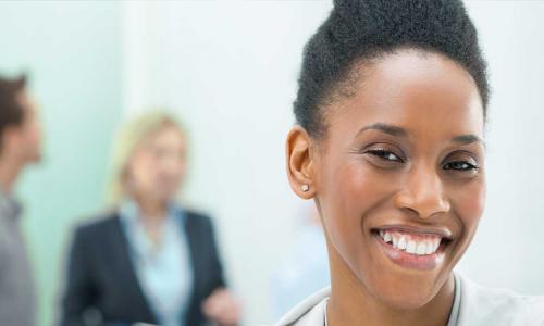 Confident young black female leader smiling