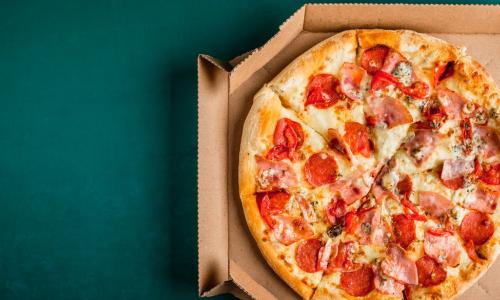 pizza in box on green background