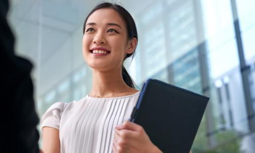 young smiling businesswoman shaking hands after negotiating promotion or job interview