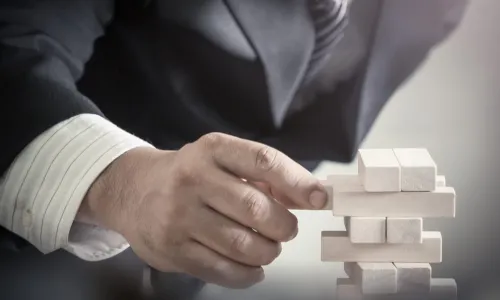 Business man decision to choosing the wood block on blurred office background