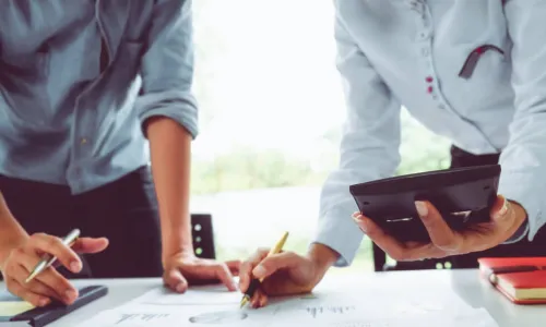 two executives work on numbers