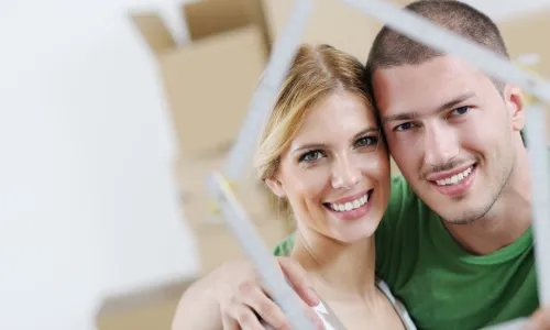 couple look through frame in shape of house