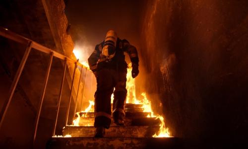firefighter going into fire, up stairs