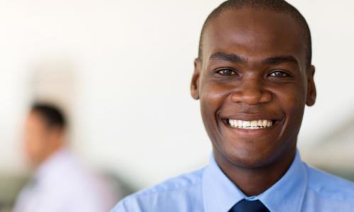 young black businessman smiling at camera