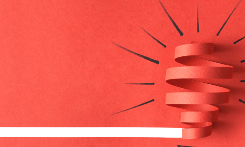 red paper cutout of a light bulb