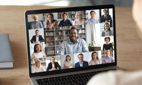 female attends virtual meeting using laptop