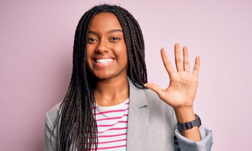 female executive with five fingers up