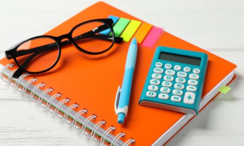 calculator with colorful office supplies