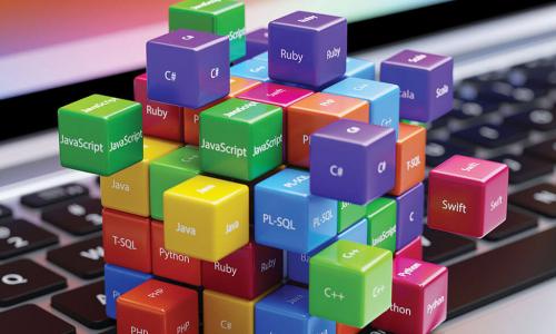 colorful blocks and cubes labeled with technology and programming language names connected together on top of laptop keyboard