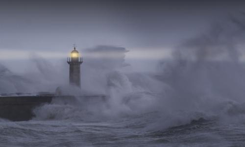 a beacon on a lighthouse in a storm