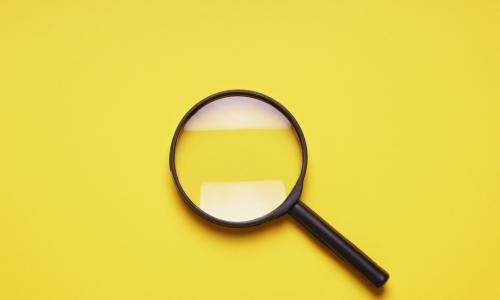 magnifying glass on yellow background 