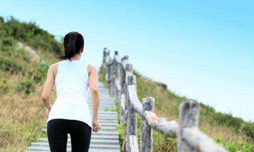 woman running on mountain stairs