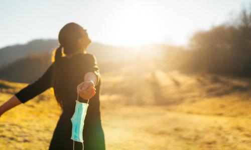 woman outdoors with mask off