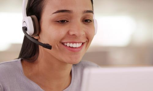 young female employee with headset and computer