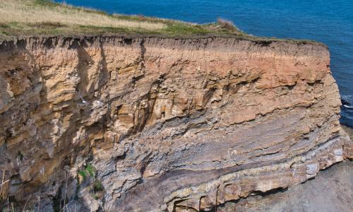 bedrock cliffs by water