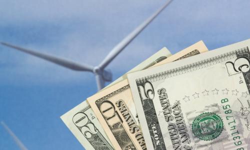 dollars with a wind turbine