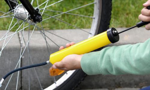 boy pumping up bicycle tire